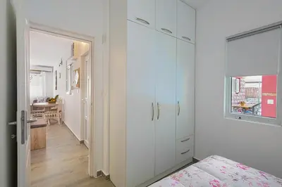 a white room with a closet and a bedroom at Apartment Kotor Bay in Kotor