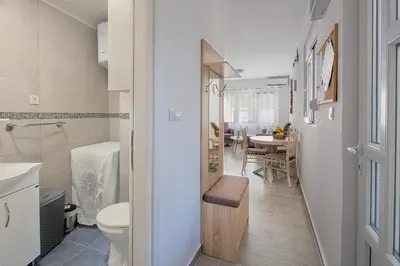 a small bathroom with a toilet and a table at Apartment Kotor Bay in Kotor