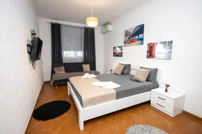 a small bedroom with a bed and a couch at PrivatHomeUlcinj2 in Ulcinj