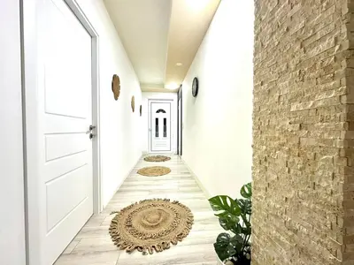 a hallway with a white door and a brick wall at PrivatHomeUlcinj1 in Ulcinj