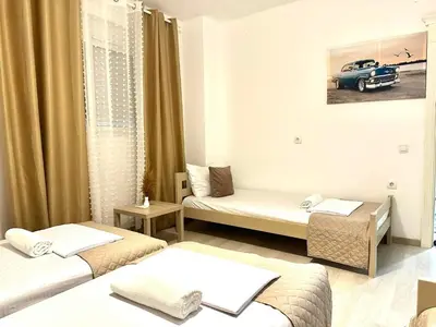 a room with three beds and a car on the wall at PrivatHomeUlcinj1 in Ulcinj