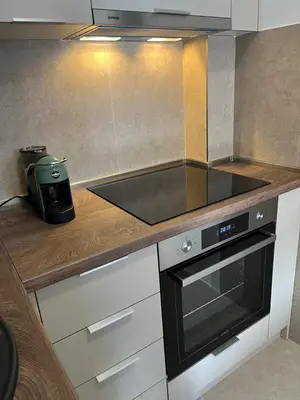 a kitchen with a sink and a stove top oven at Apartman Lux M Residence PG in Podgorica