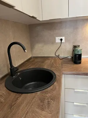 a black sink in a kitchen with a appliance at Apartman Lux M Residence PG in Podgorica