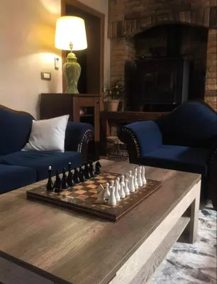 a living room with a chessboard on a table at Sicilija in Podgorica