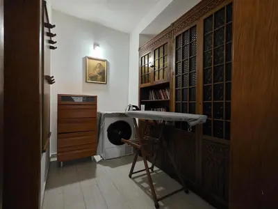 a room with a desk and a shelf with wine bottles at Sicilija in Podgorica