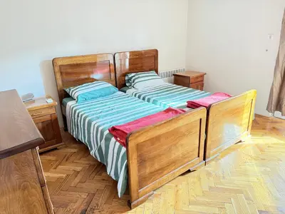 a bedroom with two beds with blue and green sheets at Charming terrace studio in Podgorica