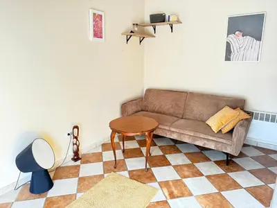 a living room with a couch and a table at Charming terrace studio in Podgorica