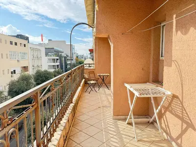 a balcony with a table and chairs on a building at Charming terrace studio in Podgorica