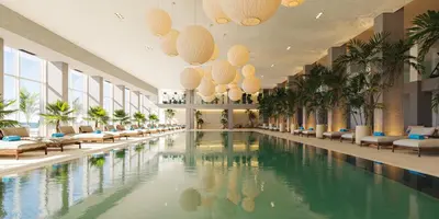 a large swimming pool in a hotel lobby with chairs at Iberostar Selection Montenegro in Bar