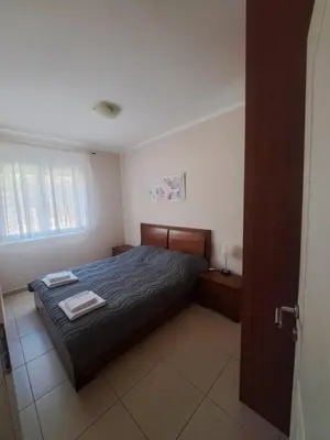 a bedroom with a bed with two towels on it at Apartman D3 in Podgorica