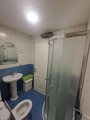 a bathroom with a toilet and a sink and a shower at Apartman D3 in Podgorica