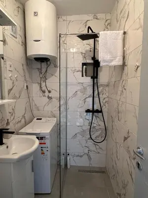a bathroom with a shower and a sink at Andrea Apartment in Podgorica