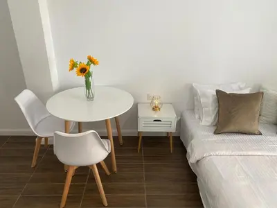 a living room with a table and a couch at Veselinka Apartments & Rooms in Budva