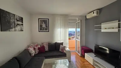 a living room with a couch and a television at Rajka Lux in Podgorica