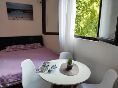 a room with a bed and a table and chairs at Apartments Four Countesses in Virpazar
