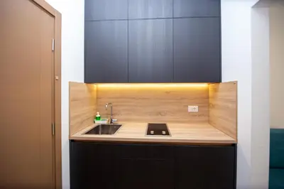 a kitchen with a sink and a wooden counter top at Apartments Sirena - Modern stay with free parking in Budva