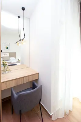 a dining room with a table and a chair at Apartments Sirena - Modern stay with free parking in Budva