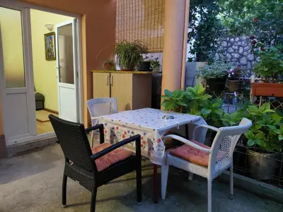 a table with two chairs and a table with at Snežana in Budva