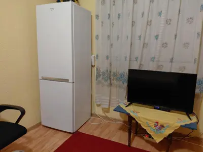 a white refrigerator and a television in a room at Snežana in Budva