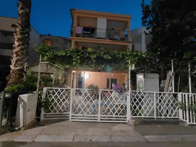 a white fence in front of a house at Snežana in Budva