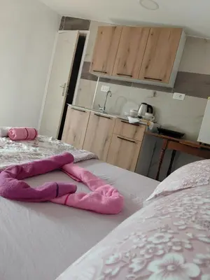 a pair of towels sitting on top of a bed at Studio apartman Milena 1 in Podgorica