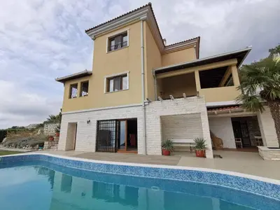 a house with a swimming pool in front of it at Lux Villa Provence in Budva