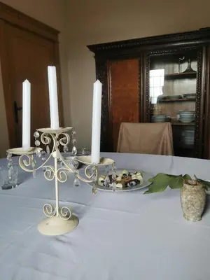 a table with two candlesticks and a plate with three candles at Lux Villa Provence in Budva