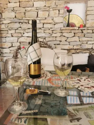a bottle of wine and two glasses on a table at Lux Villa Provence in Budva