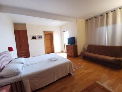 a bedroom with a bed and a couch at Lux Villa Provence in Budva