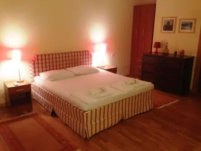 a bedroom with a large bed with two night stands and two lamps at Lux Villa Provence in Budva