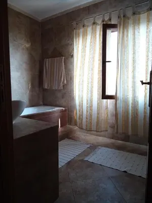 a bathroom with a tub and a window at Lux Villa Provence in Budva