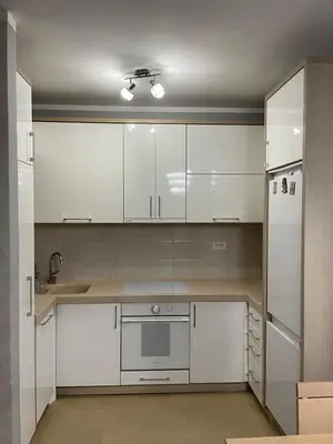 a kitchen with white cabinets and a sink at Apartment Peace in Podgorica