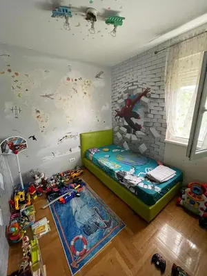 a childs room with a bed and toys on the floor at Apartment Peace in Podgorica