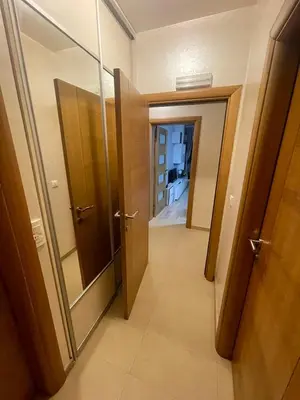 a hallway with a door and a mirror in a room at Apartment Peace in Podgorica