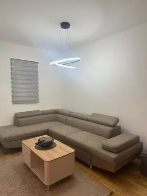 a living room with a couch and a table at Studio apartman in Budva