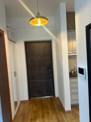 a hallway with a door in a room with a kitchen at Studio apartman in Budva