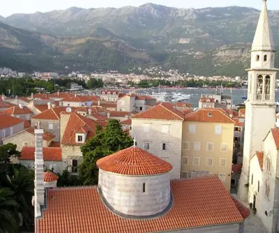 a view of a town with a tower and a church at Apartmani Vila Marija in Budva