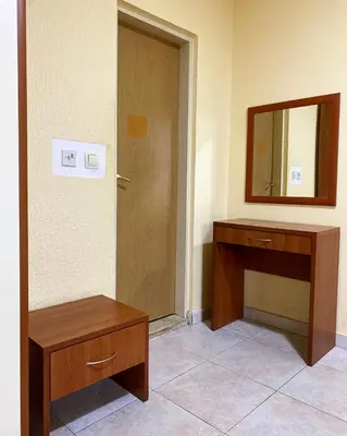 a bathroom with a vanity and a mirror and a door at Apartmani Vila Marija in Budva