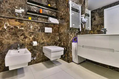 a bathroom with a toilet and a sink at DeLux and Urban apartments Hotel Tre Canne Budva in Budva