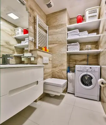 a laundry room with a washer and dryer at DeLux and Urban apartments Hotel Tre Canne Budva in Budva