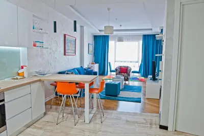 a kitchen and living room with a table and chairs at DeLux and Urban apartments Hotel Tre Canne Budva in Budva