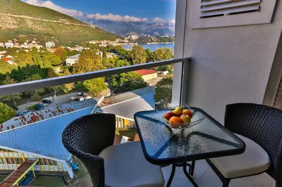 a bowl of fruit on a table on a balcony at DeLux and Urban apartments Hotel Tre Canne Budva in Budva