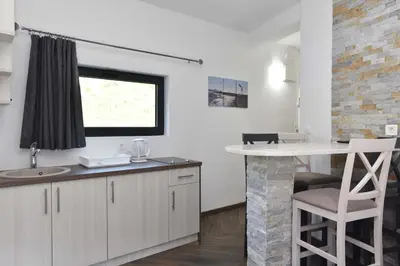 a kitchen with a counter and a sink and a window at Lux Čanj in Čanj