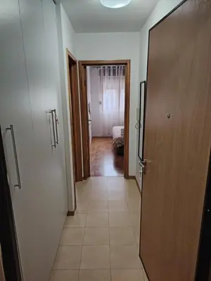 a hallway with a door leading to a bedroom at Sicilija apartment in Podgorica