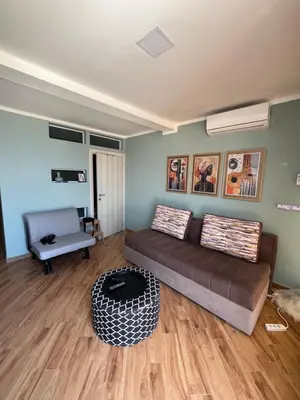 a living room with a couch and a chair at Cherry in Dobra Voda