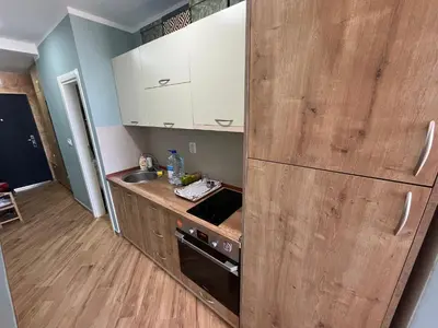 a kitchen with wooden cabinets and a counter top at Cherry in Dobra Voda