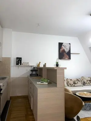 a living room with a couch and a table at Apartment little paradise in Podgorica