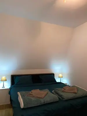 a bedroom with a bed with two towels on it at Apartment little paradise in Podgorica