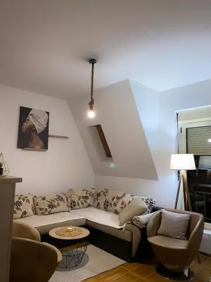 a living room with a couch and two chairs at Apartment little paradise in Podgorica