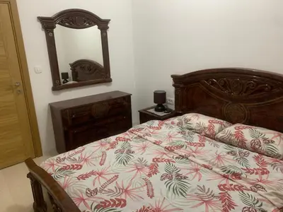 a bedroom with a bed and a mirror at Apartman SA&BO in Podgorica